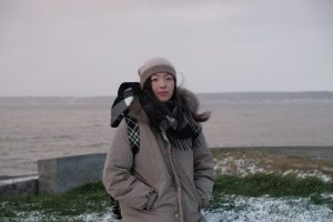 MSIL student Linda Wang posing in front of a body of water during Denmark immersion trip.